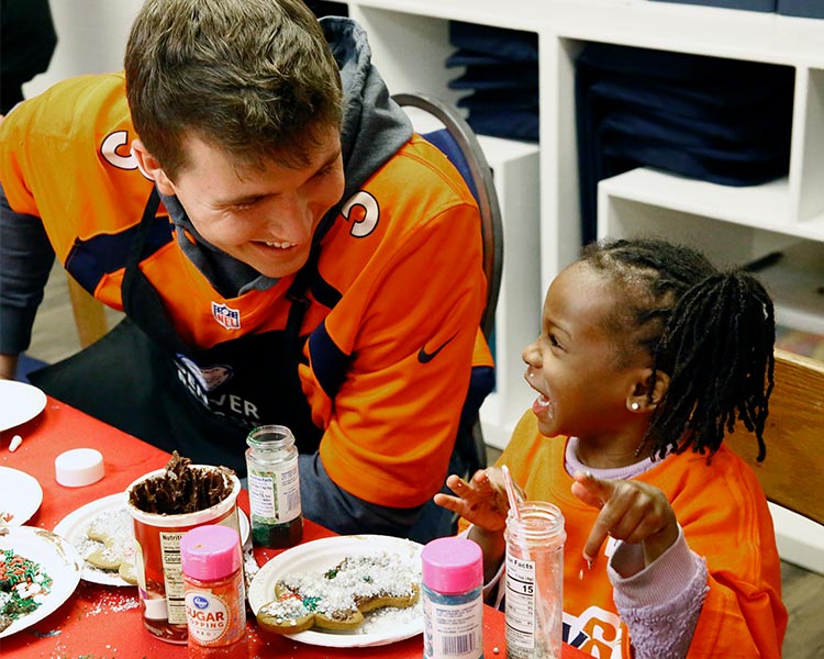 Denver Broncos Bring Holiday Cheer (and a Newly Renovated Space!) to the Mission’s Families