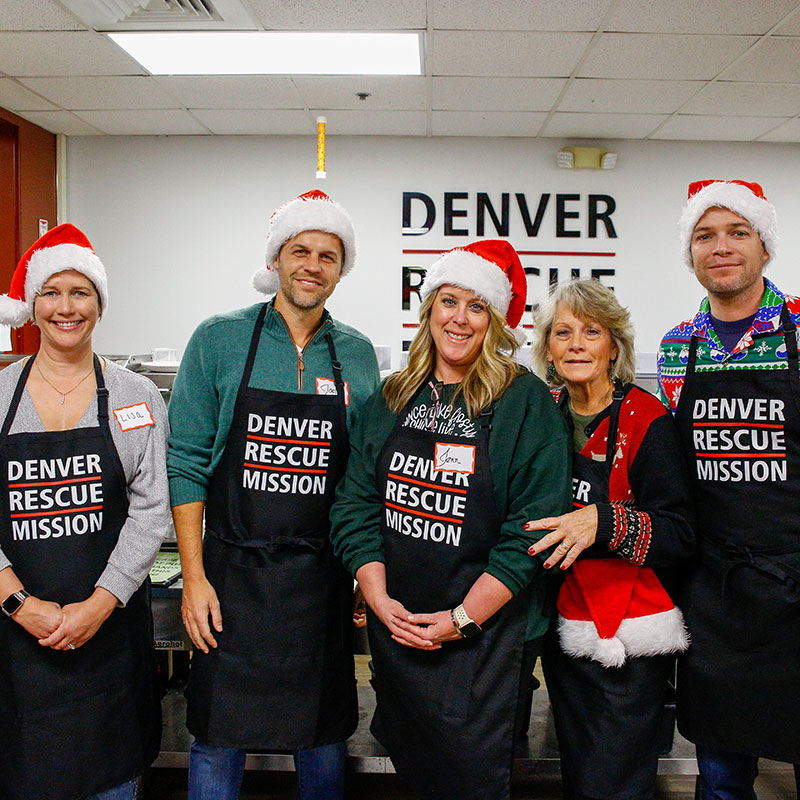 Christmas 2022 - Five volunteers at The Crossing in Santa Hats