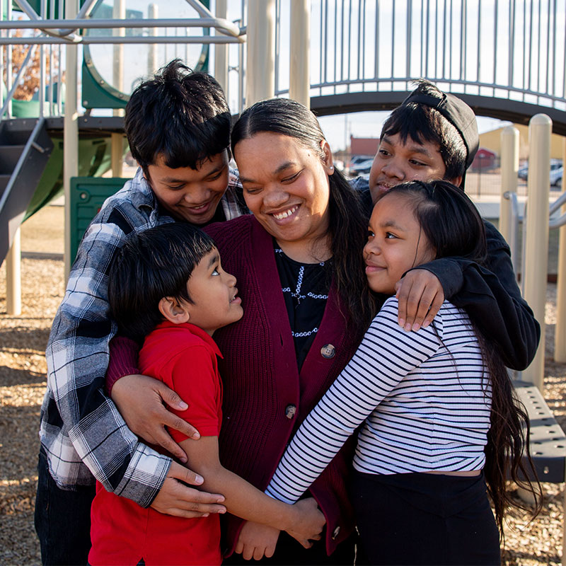 Kalina hugging her children