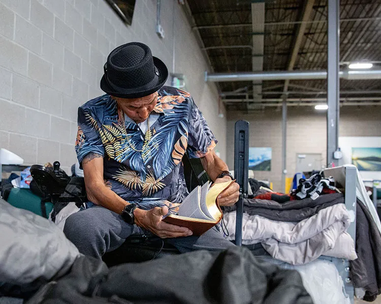 Randy reading his bible in shelter
