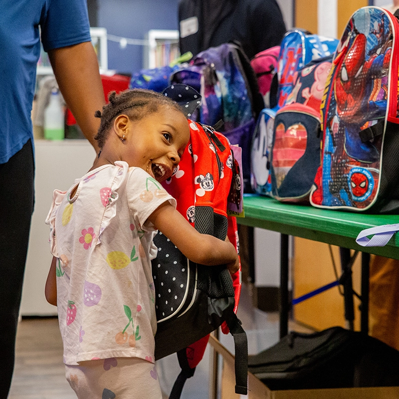 Child receiving backpack