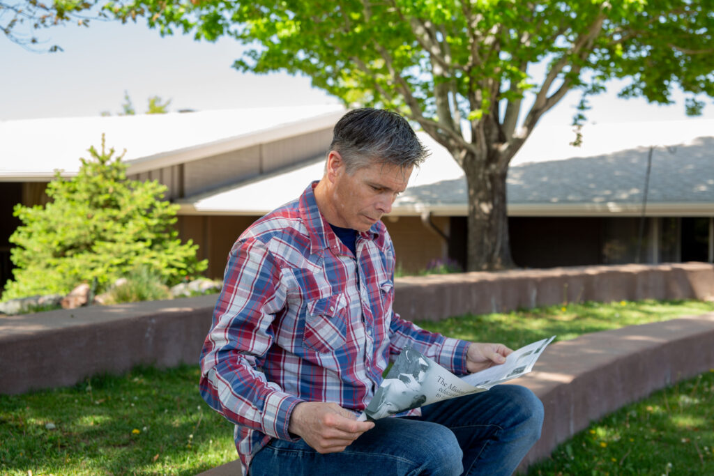 Charles reading his father's newsletter